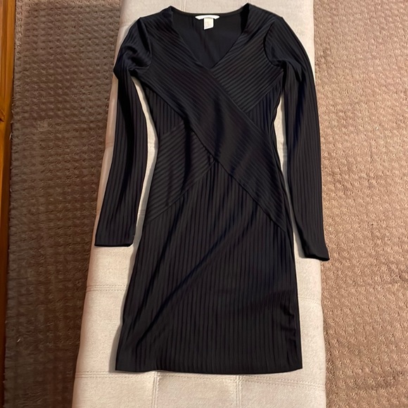 H&M Dresses & Skirts - NEW Really cute little sexy black dress. Has Chris crossed details on the front